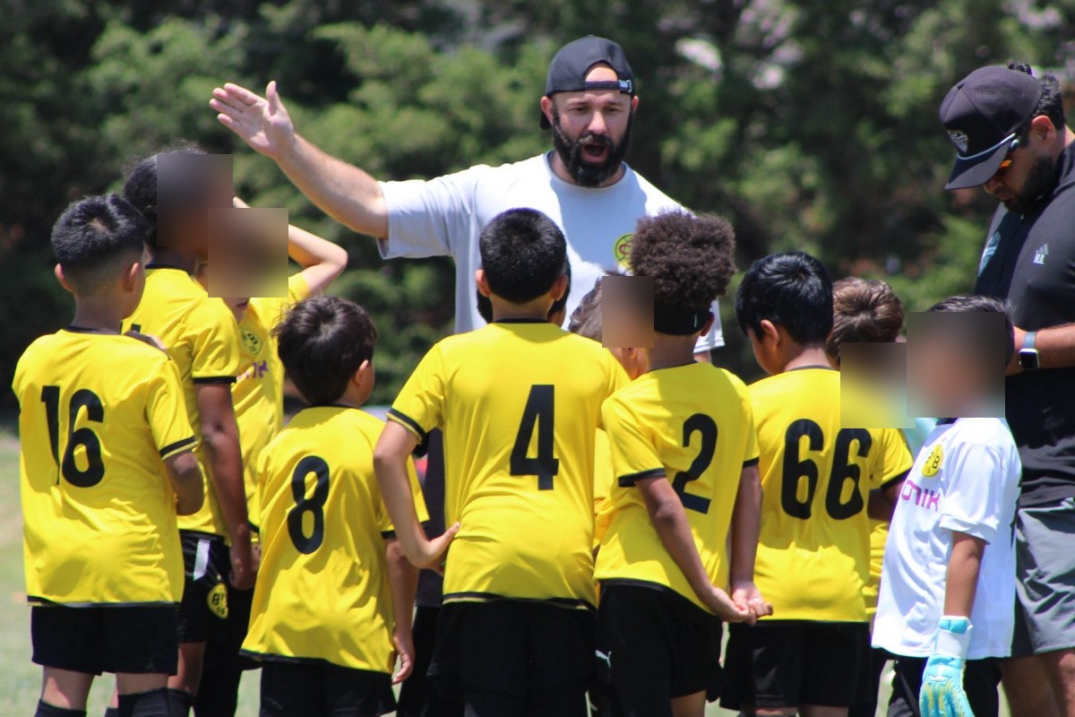 Jordan Hoffnagle coaching a youth soccer team in Dallas